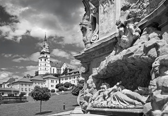 Kremnica  - The Safarikovo square and detail of the baroque Holy Trinity column by Dionyz Ignac Stanetti (1765 - 1772), castle and St. Catherine church.
