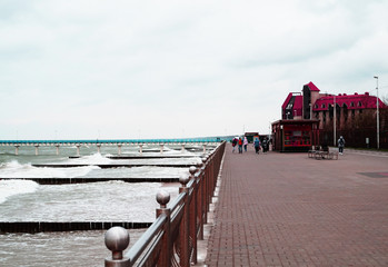 Promenade overlooking the Baltic sea with pier and breakwaters in Kaliningrad, Russia, may 2019,...