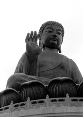 Large seated Buddha with raised hand and palm facing outward 