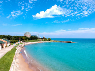 Chicago,IL/USA-September 18 2019: aerial drone footage of the city of Chicago planetarium and beach by lake Michigan during a high afternoon. the wave flow upon sure as people tour around the lake