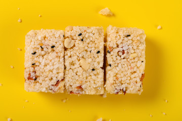 top view traditional Chinese crisp rice block with peanuts on yellow background