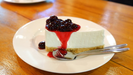 Cake berry on wooden table in coffee shop