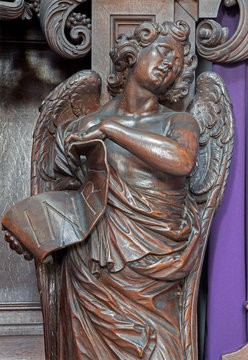 MECHELEN - SEPTEMBER 4: Carved angel statue with the Inri inscription from Onze-Lieve-Vrouw-va n-Hanswijkbasiliek church on September 4, 2013 in Mechelen, Belgium.