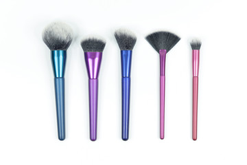 Set of colorful brushes for makeup isolated on white background.