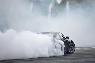 Motion Blur side view drift car. Drift car with  smoke from burning tires. - obrazy, fototapety, plakaty