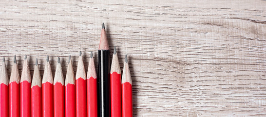 Black pencil different from crowd of red pencils. Unique Leader, strategy, independence, think different, business and success concept