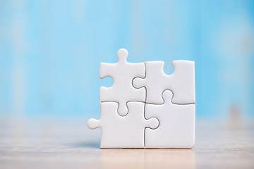 puzzle pieces on wood table background. Business solutions, mission target, successful, goals, cooperation, partnership and strategy concept