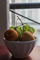 Fruits, grapes and apricots served in a bowl