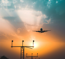 airplane landing on sunset