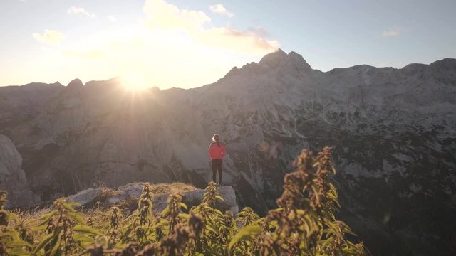 Hiking through the Julian Alps in the Triglav National Park in Slovenia. Hiking to a viewpoint during summer to watch the sunset from a summit