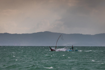 Fisherman boat in the storm sea, Thailand