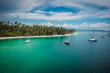 Fototapeta na wymiar Sail boats docked by beautiful islands