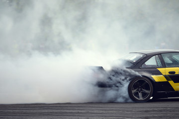 Motion blur close up drift car with  smoke from burning tires