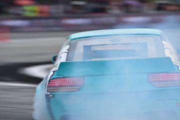 Motion blur close up drift car with  smoke from burning tires