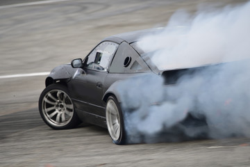 Motion Blur side view drift car . Drift car with  smoke from burning tires.