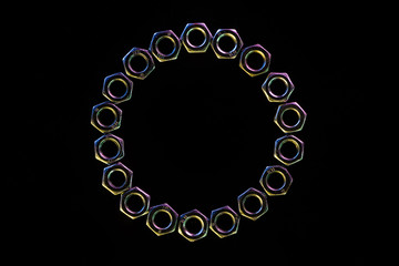close up view of steel nuts circle isolated on black with copy space