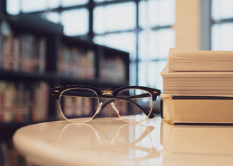 glasses on book at library and copyspace , education concept.
