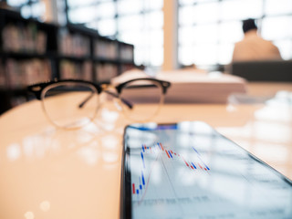 candle stick bar chart forex trading at working table with copyspace , business concept.