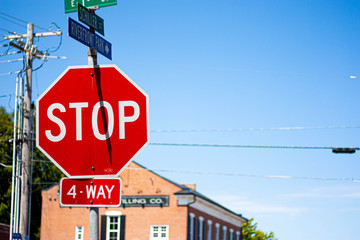 Obraz premium red stop sign on background of blue sky, warehouse and clouds