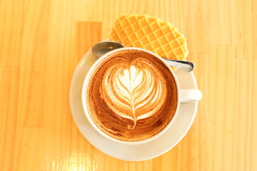 cup of coffee with cookie on white background