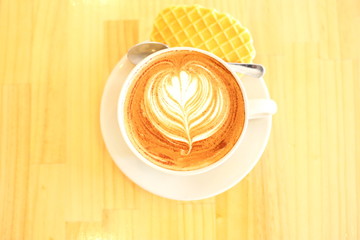 cup of tea with cookie on wooden background