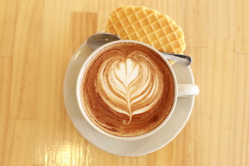 cup of coffee with cookies on white background