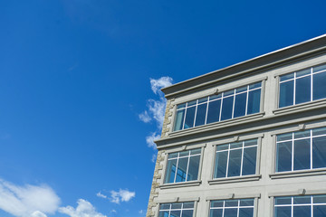 Fragment of the office building by modern architecture on blue sky background