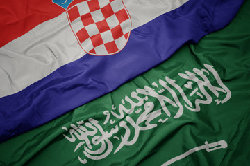 waving colorful flag of saudi arabia and national flag of croatia.