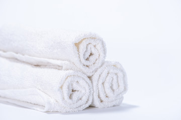 Gently rolled terry towels for spa or massage on a white background