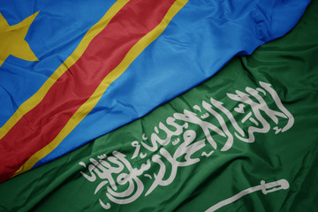 waving colorful flag of saudi arabia and national flag of democratic republic of the congo.