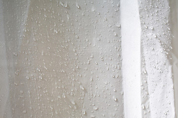 Wet white wrinkled shower curtain with water drops, steam shower on white background, Light and shadow, Bathroom concept