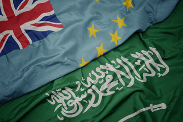 waving colorful flag of saudi arabia and national flag of Tuvalu .