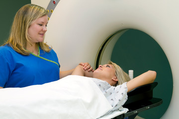 Healthcare Worker Comforting Woman Receiving CAT Scan for Breast Cancer Diagnosis