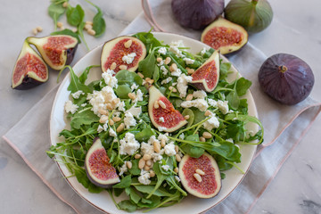 Healthy Fig salad with feta cheese, nuts and aru