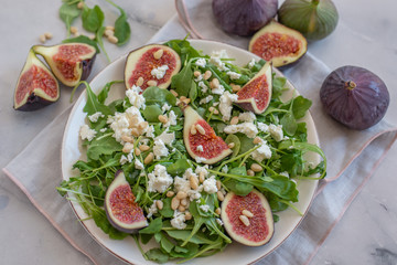 Healthy Fig salad with feta cheese, nuts and aru