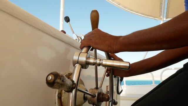 Steering wheel on motorboat used by boat captain on ship or yacht bridge