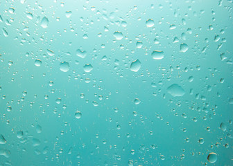Close-up shot of water drop on transparent glass after raining.