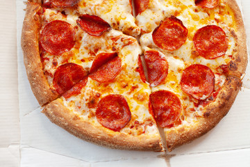 Hot pepperoni pizza in a cardboard box