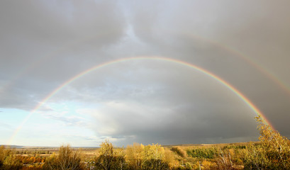 rainbow after rain against a stormy sky