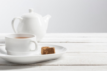 cup of tea with chocolate candy on wooden table
