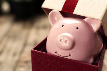 Piggy bank in the gift box celebration on holiday concept.