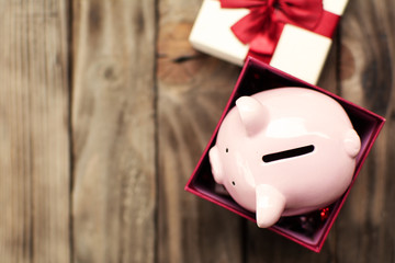 Piggy bank in the gift box celebration on holiday concept.