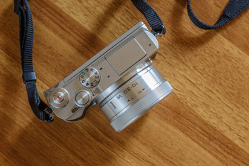 top view of retro camera on wooden table..