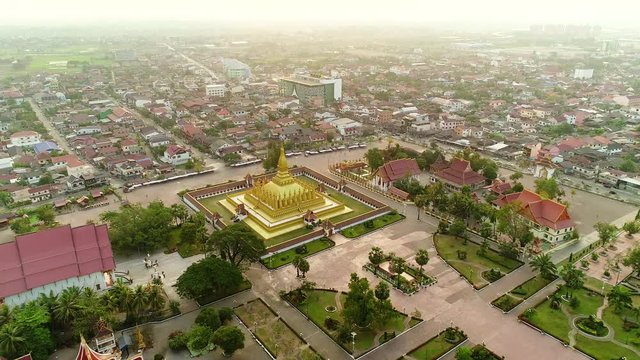 4k Video shot aerial view by drone of Wat Phra That Luang , Vientiane, Laos PDR. sunrise on Lao landmark temple.	