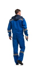 Man in blue work clothes isolated rearview