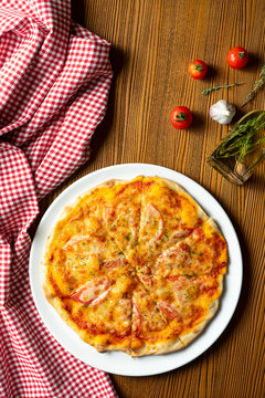 Fresh homemade Margarita pizza on a wooden background in composition with a red cloth and olive oil. Italian Cuisine. Top view food photo