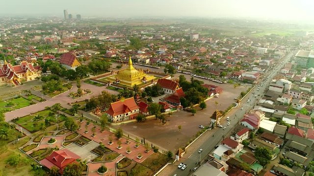 4k Video shot aerial view by drone of Wat Phra That Luang , Vientiane, Laos PDR. sunrise on Lao landmark temple.	