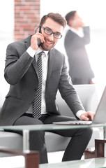 image of young businessman talking on mobile phone with clients