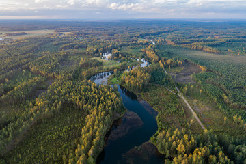 Aerial view of river among the forest. Summer nature landscape. Sunset.