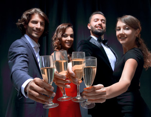 Cheerful people celebrating a sucess with Champagne